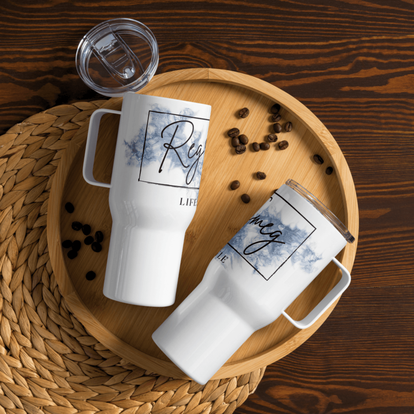 Travel mug featuring Reg Smeg Lifestyle logo with script typography and watercolor accents.